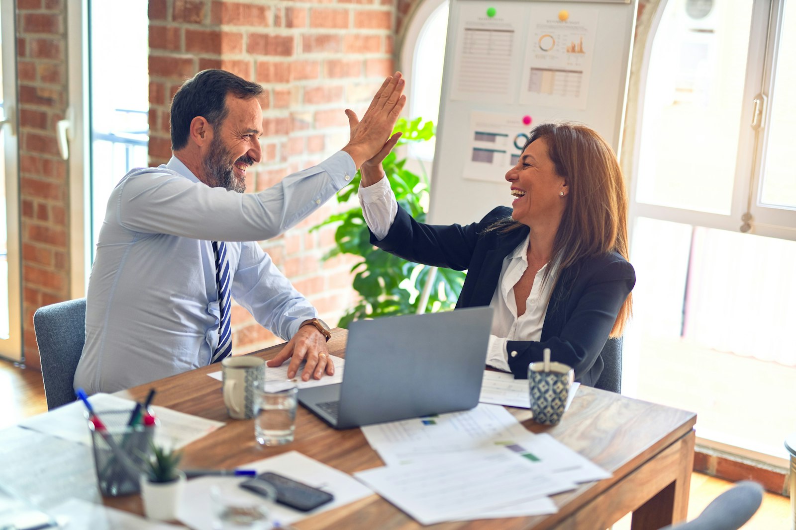 Hiring conversation at a meeting table — placeholder photograph